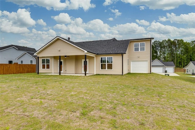 view of front facade featuring a patio, roof with shingles, and a garage