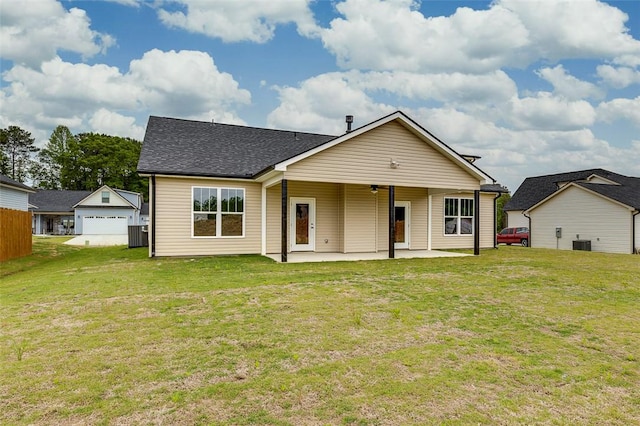 view of front facade with a patio area, a front yard, and central AC unit