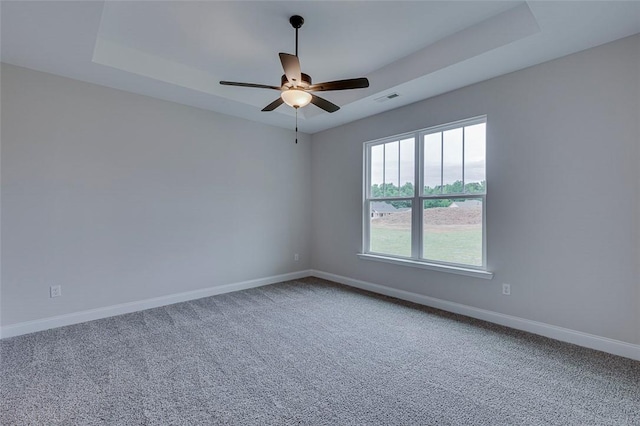 carpeted spare room with baseboards and ceiling fan