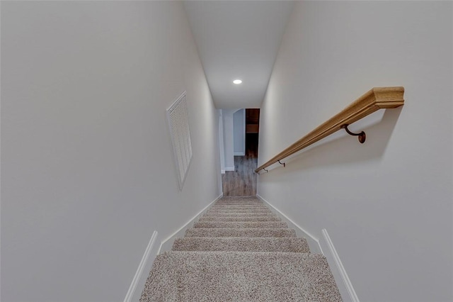 stairs with carpet, recessed lighting, and baseboards