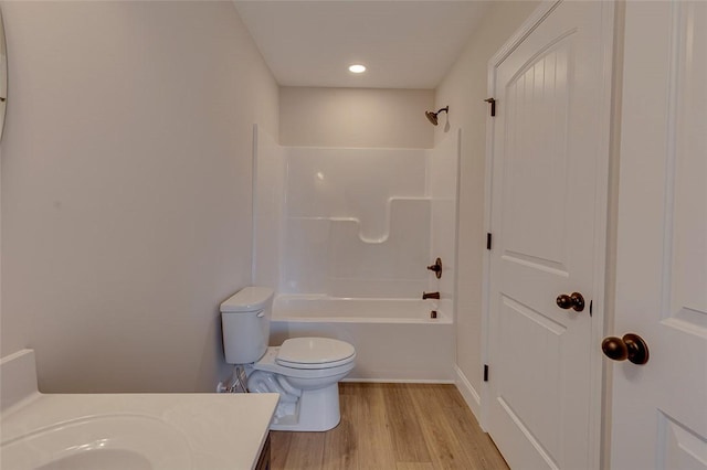 full bathroom with toilet, wood finished floors, shower / washtub combination, and vanity