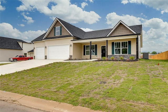 craftsman inspired home with covered porch, concrete driveway, stone siding, central air condition unit, and an attached garage