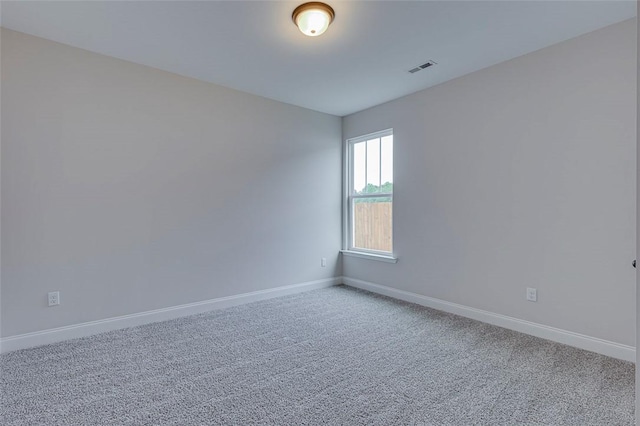 unfurnished room with baseboards and carpet floors