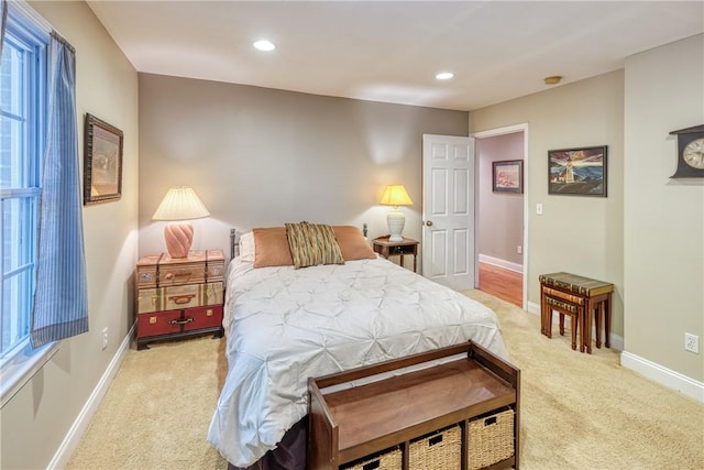 bedroom featuring baseboards, light carpet, and recessed lighting