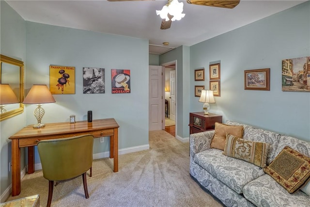 carpeted home office featuring baseboards and ceiling fan