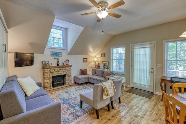 living room with lofted ceiling, baseboards, light wood-style floors, and ceiling fan