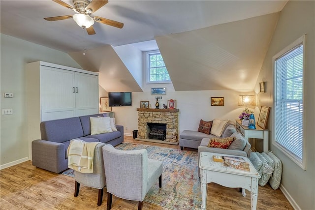 living area featuring baseboards, vaulted ceiling, wood finished floors, and ceiling fan