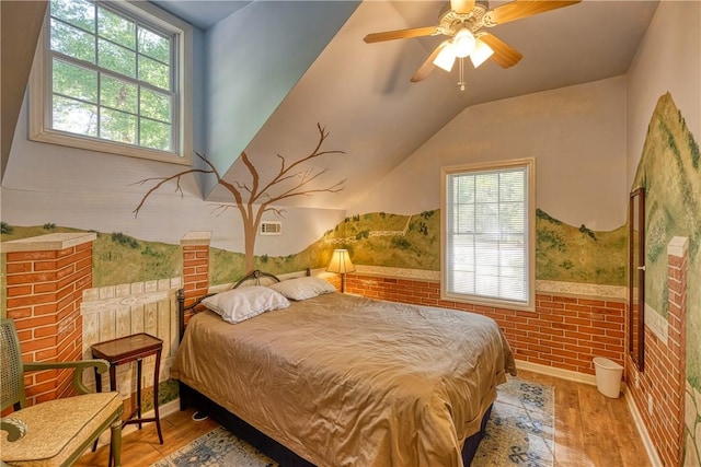 bedroom with ceiling fan, lofted ceiling, wood finished floors, and baseboards