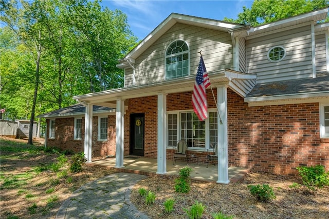 traditional home with brick siding and a porch