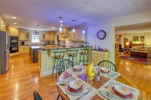 dining area featuring light wood-style floors and recessed lighting