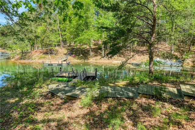 view of yard featuring a boat dock and a water view