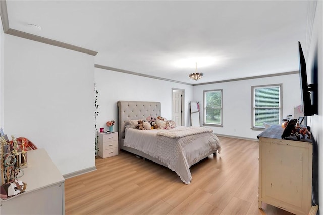 bedroom with crown molding, light wood finished floors, and baseboards