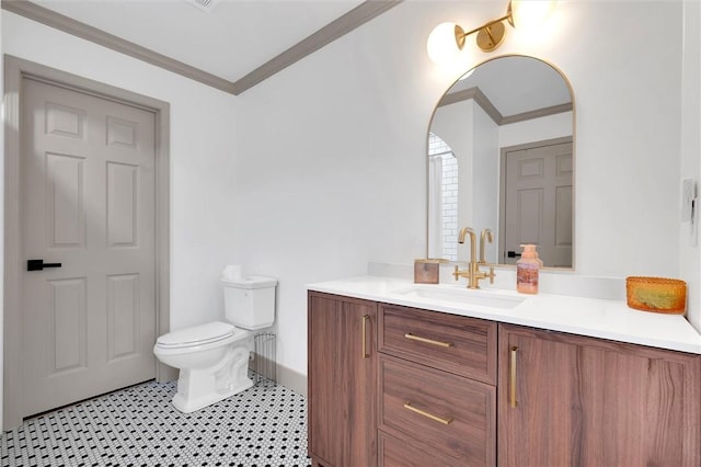 bathroom featuring toilet, vanity, tile patterned floors, and crown molding