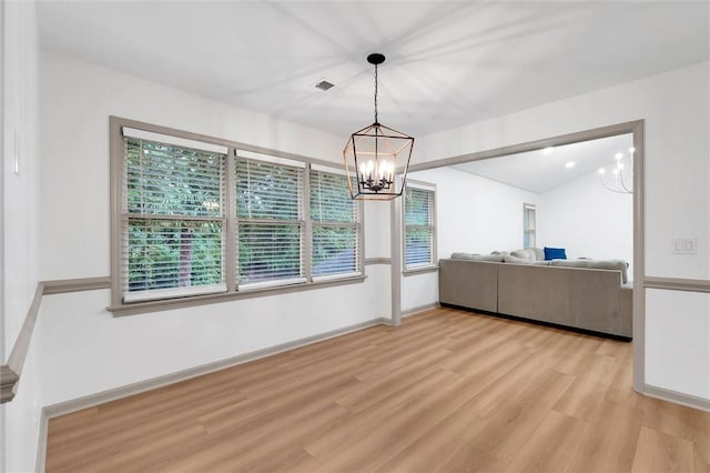 dining space featuring light wood-style flooring, visible vents, a notable chandelier, and a healthy amount of sunlight