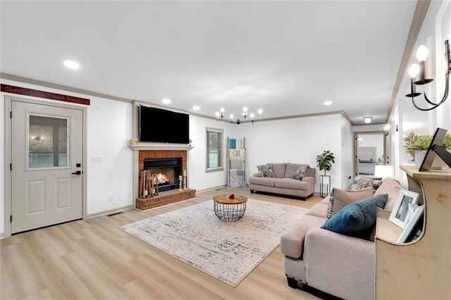 living area with recessed lighting, crown molding, light wood-style floors, and a fireplace