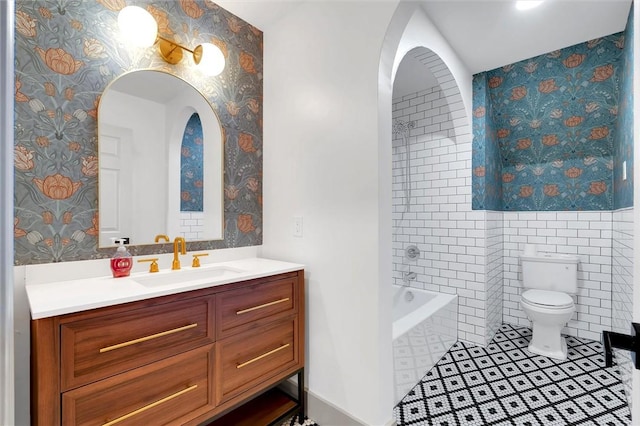 bathroom with wallpapered walls, toilet, vanity, and tile patterned floors