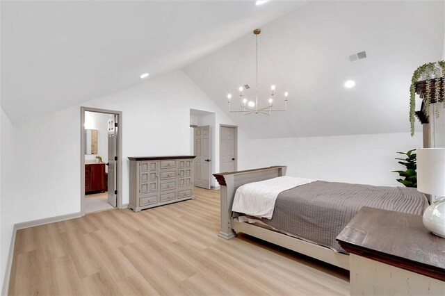 bedroom with vaulted ceiling, visible vents, connected bathroom, light wood-style flooring, and a notable chandelier
