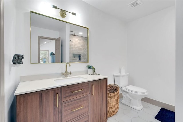 bathroom featuring tile patterned floors, vanity, walk in shower, toilet, and visible vents