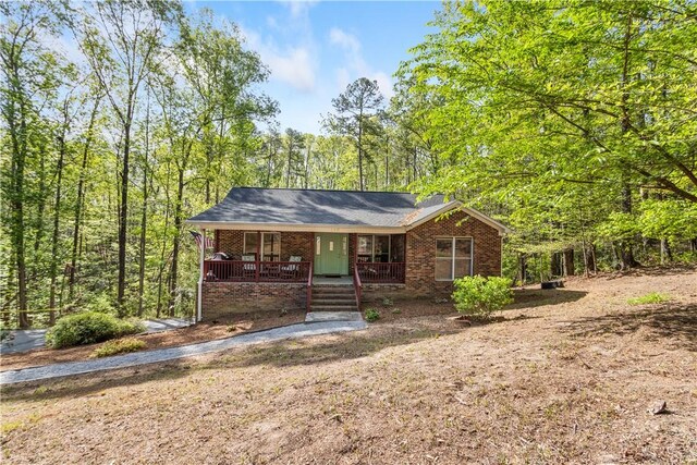 view of front of home with covered porch and brick siding
