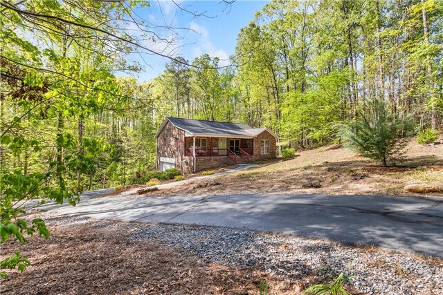 exterior space with a view of trees and driveway
