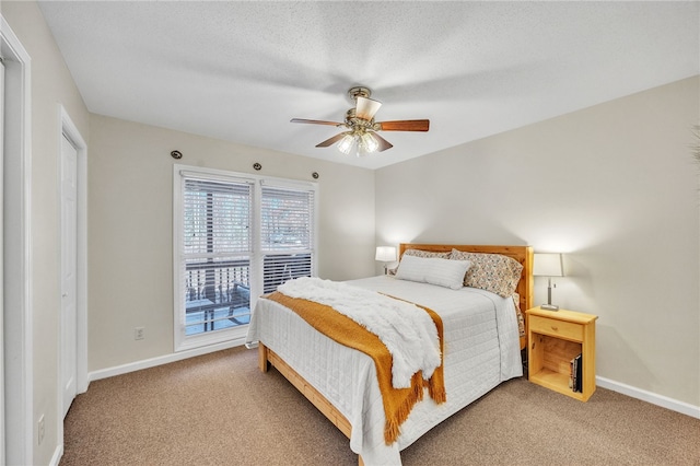 carpeted bedroom with baseboards and ceiling fan