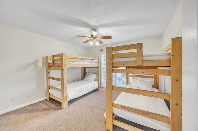 bedroom with baseboards and carpet