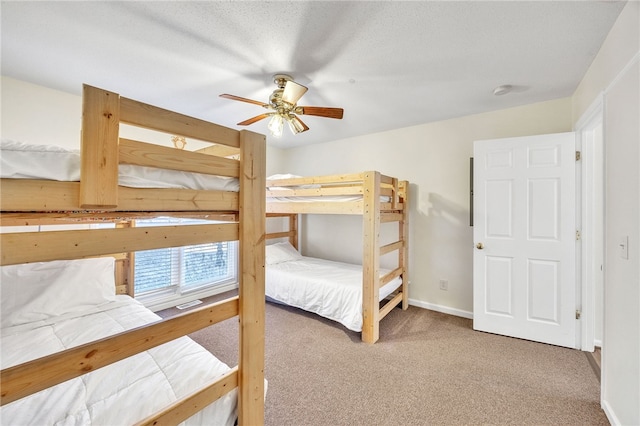 carpeted bedroom with baseboards and a ceiling fan