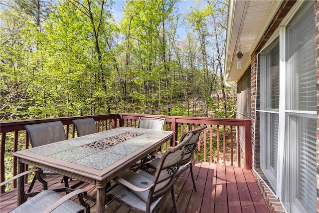 wooden deck featuring outdoor dining area