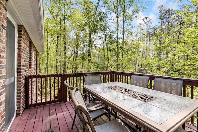 wooden terrace featuring outdoor dining area