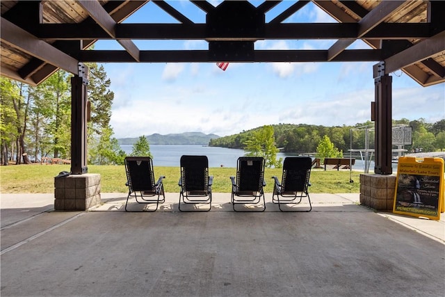 view of patio with a water and mountain view