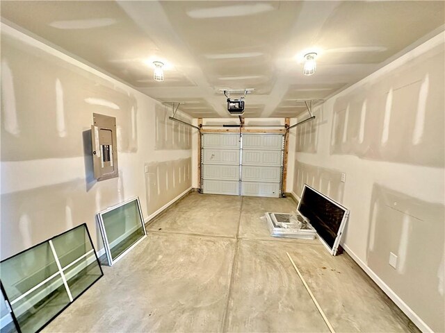 garage with electric panel, baseboards, and a garage door opener