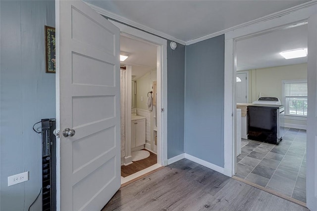 interior space featuring washer / dryer, wood finished floors, and baseboards