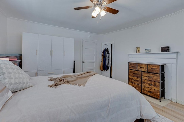 bedroom with a ceiling fan, crown molding, and light wood-type flooring