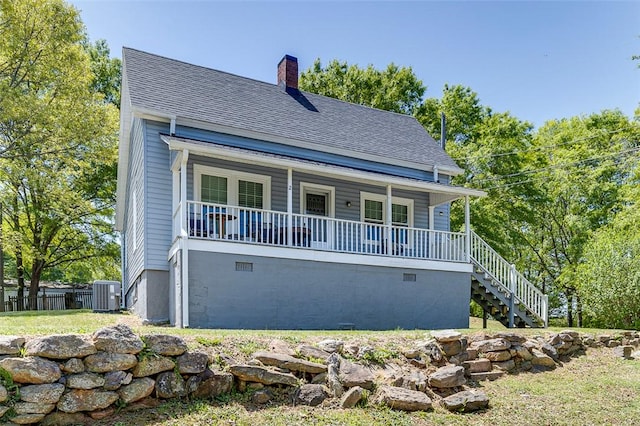 view of front of home with roof with shingles, a porch, central AC, a chimney, and stairs