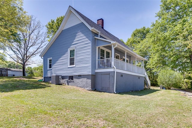 view of property exterior with cooling unit, a yard, a chimney, and stairway
