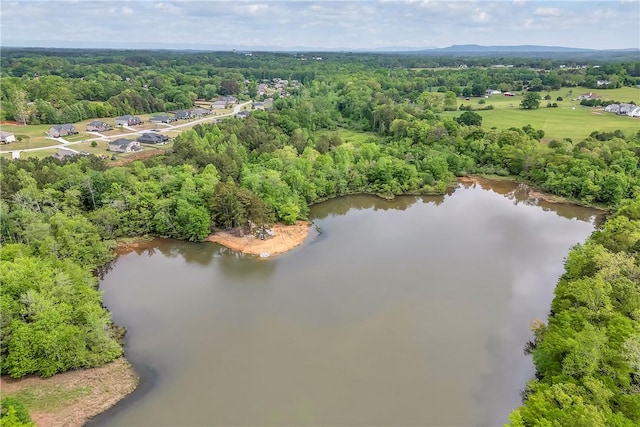 aerial view featuring a forest view and a water view