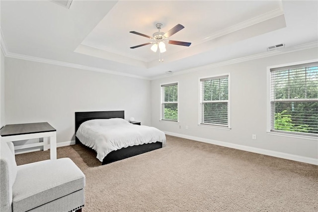 bedroom with visible vents, carpet floors, a raised ceiling, and crown molding