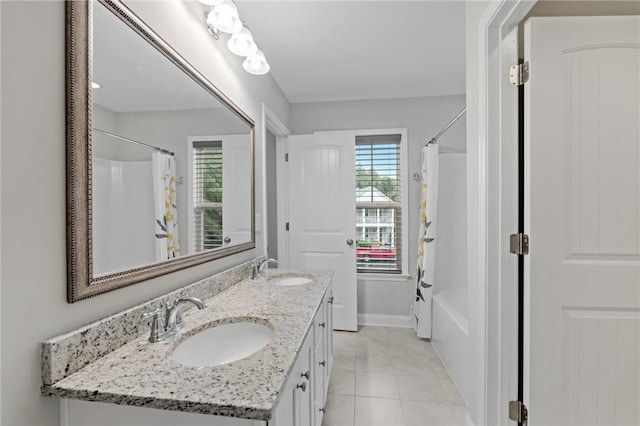 full bath with tile patterned flooring, a sink, and plenty of natural light
