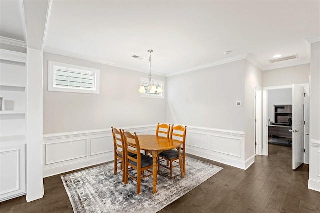 dining area with wainscoting, dark wood finished floors, ornamental molding, and visible vents
