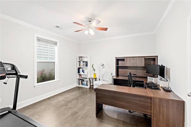 home office with visible vents, a ceiling fan, wood finished floors, and crown molding