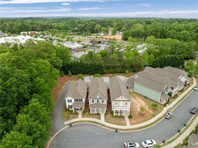 bird's eye view with a wooded view