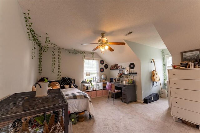 bedroom with light carpet, a textured ceiling, vaulted ceiling, visible vents, and ceiling fan