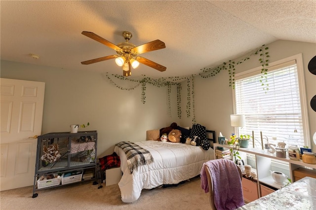 carpeted bedroom featuring lofted ceiling, a textured ceiling, and a ceiling fan