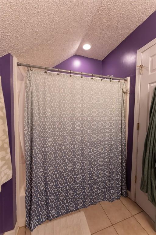 bathroom featuring a shower with curtain, tile patterned flooring, a textured ceiling, and recessed lighting