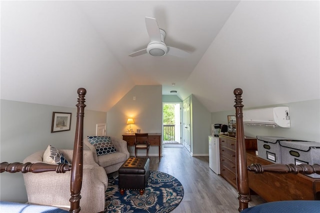 bedroom with vaulted ceiling, wood finished floors, an AC wall unit, access to outside, and ceiling fan