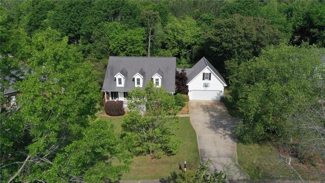 birds eye view of property featuring a view of trees