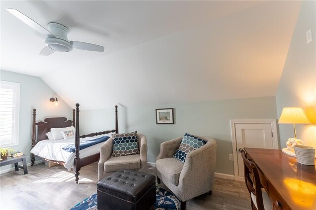 bedroom with lofted ceiling, baseboards, wood finished floors, and ceiling fan