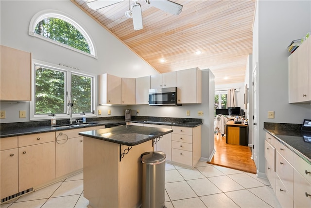 kitchen featuring a sink, light tile patterned floors, wooden ceiling, stainless steel microwave, and visible vents