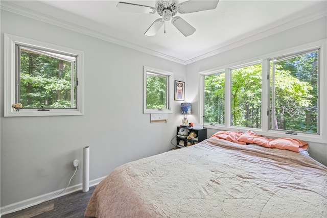 bedroom with crown molding, a ceiling fan, baseboards, and dark wood-style flooring