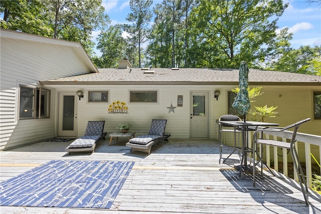 back of house with a deck